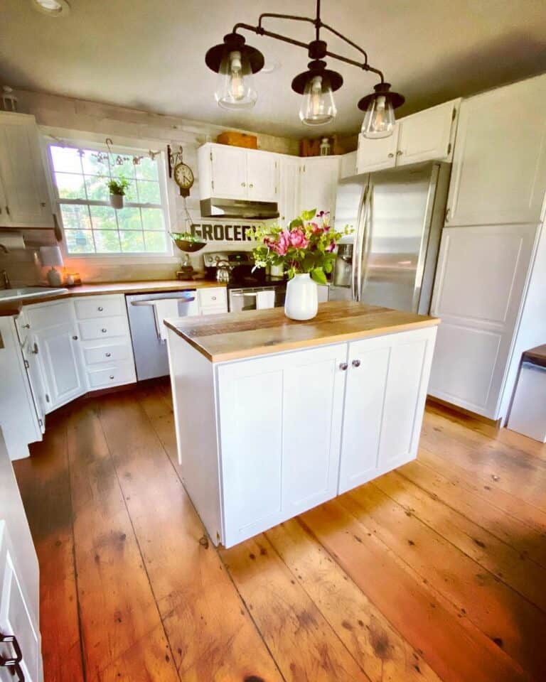Wooden-floored Kitchen With White Island