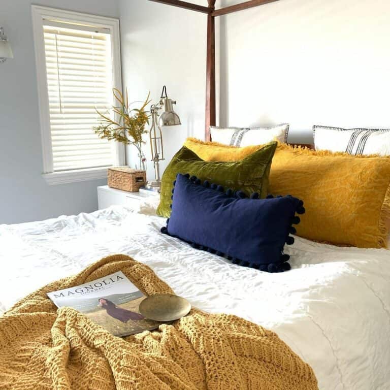 Yellow Bedroom With Vibrant Pillows and Quilts