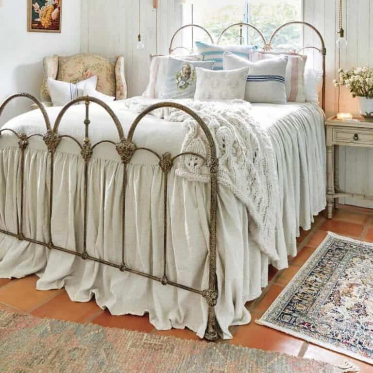 Antique Cast Iron Bed With White Knit Throw