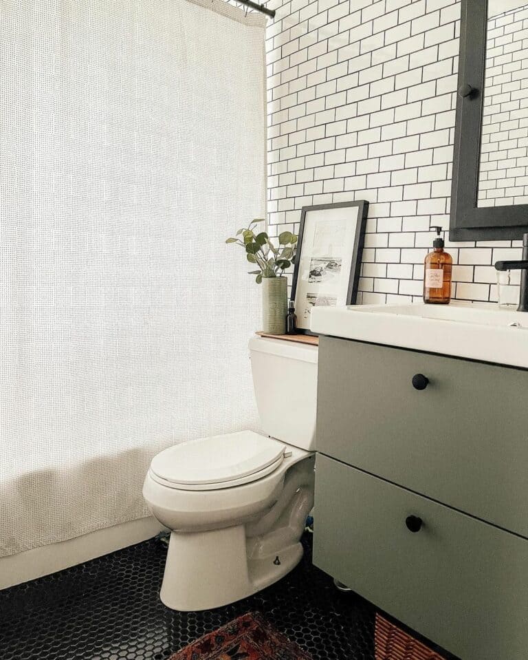 Bathroom With Small Black Penny Tile Flooring