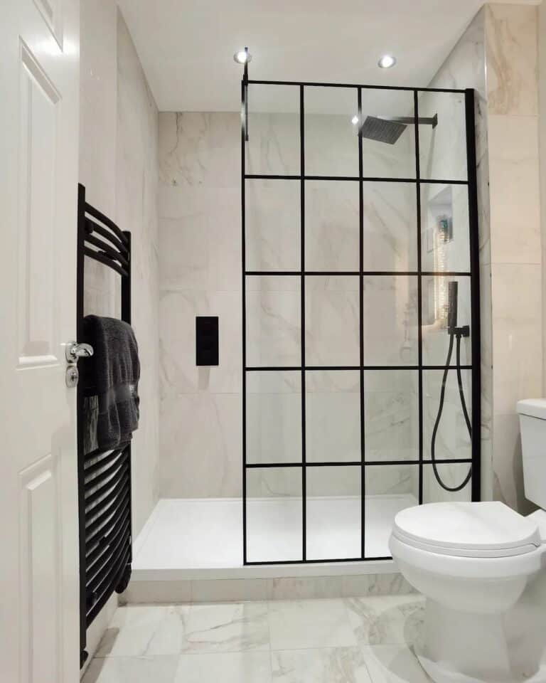 Bathroom With a Black-accented Glass Shower Enclosure