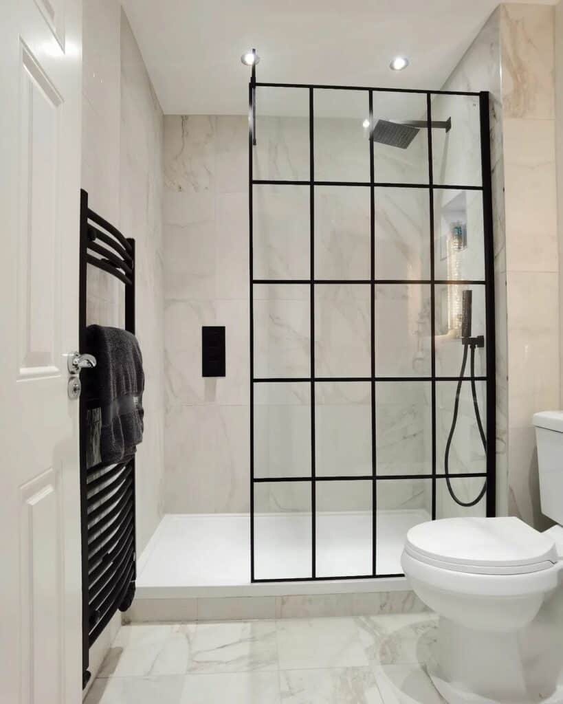 Bathroom With a Black-accented Glass Shower Enclosure
