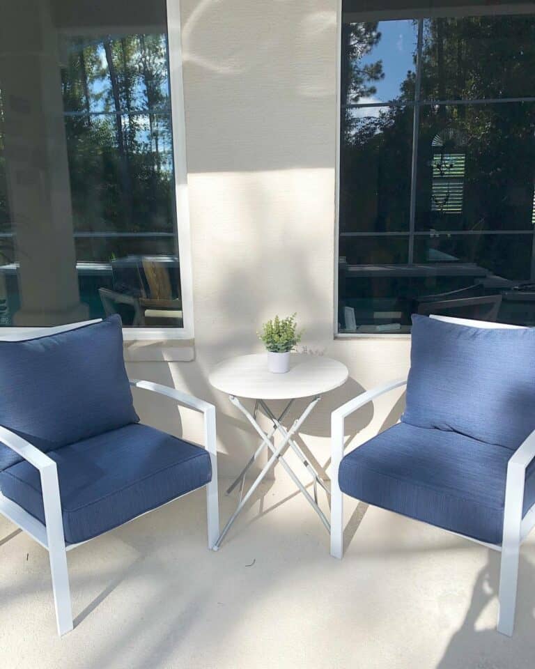 Beige Porch With White and Navy Chairs