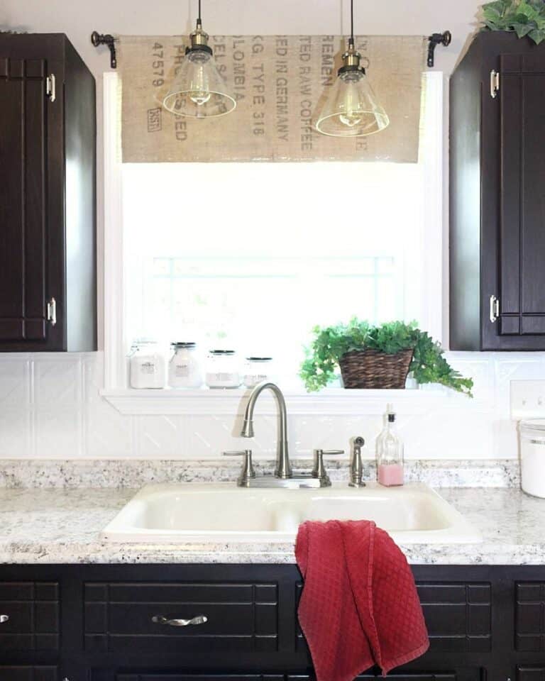 Black Kitchen Cabinets and a Red Towel