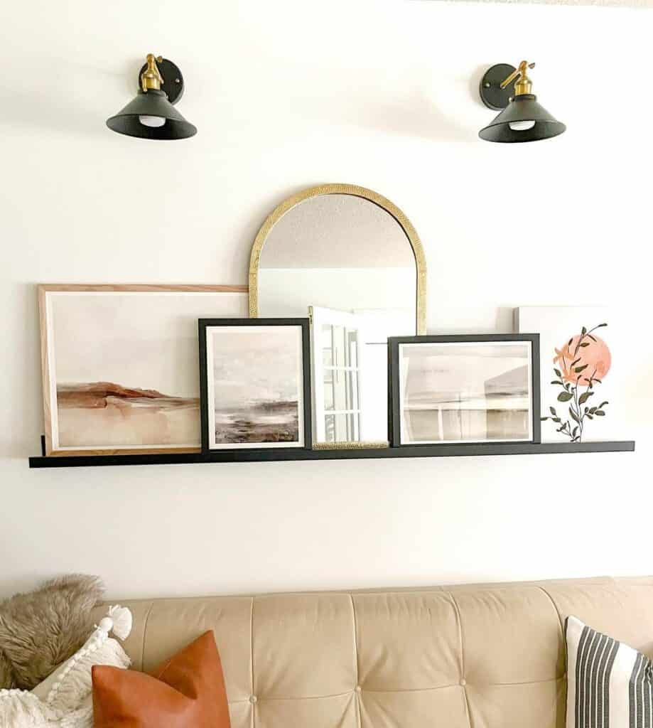 Black Sconces Illuminating a Floating Shelf