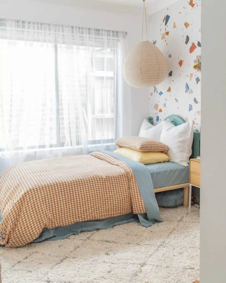 Blue Bed Against Terrazzo Wallpaper