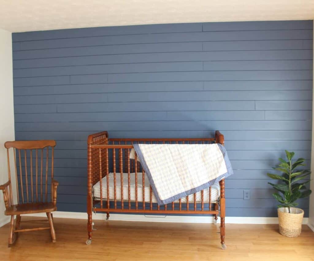 Blue Shiplap Walls With Wooden Crib