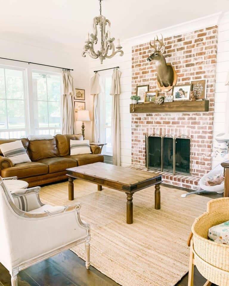 Brick Living Room Fireplace With Deer Head Décor