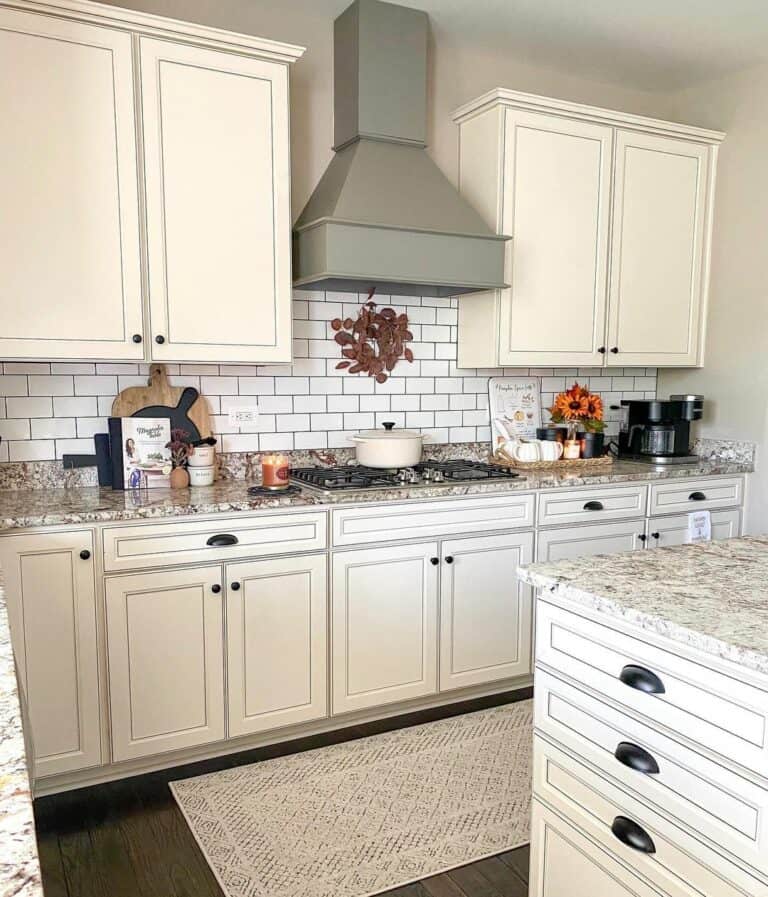 Cream kitchen cabinets with black countertops deals
