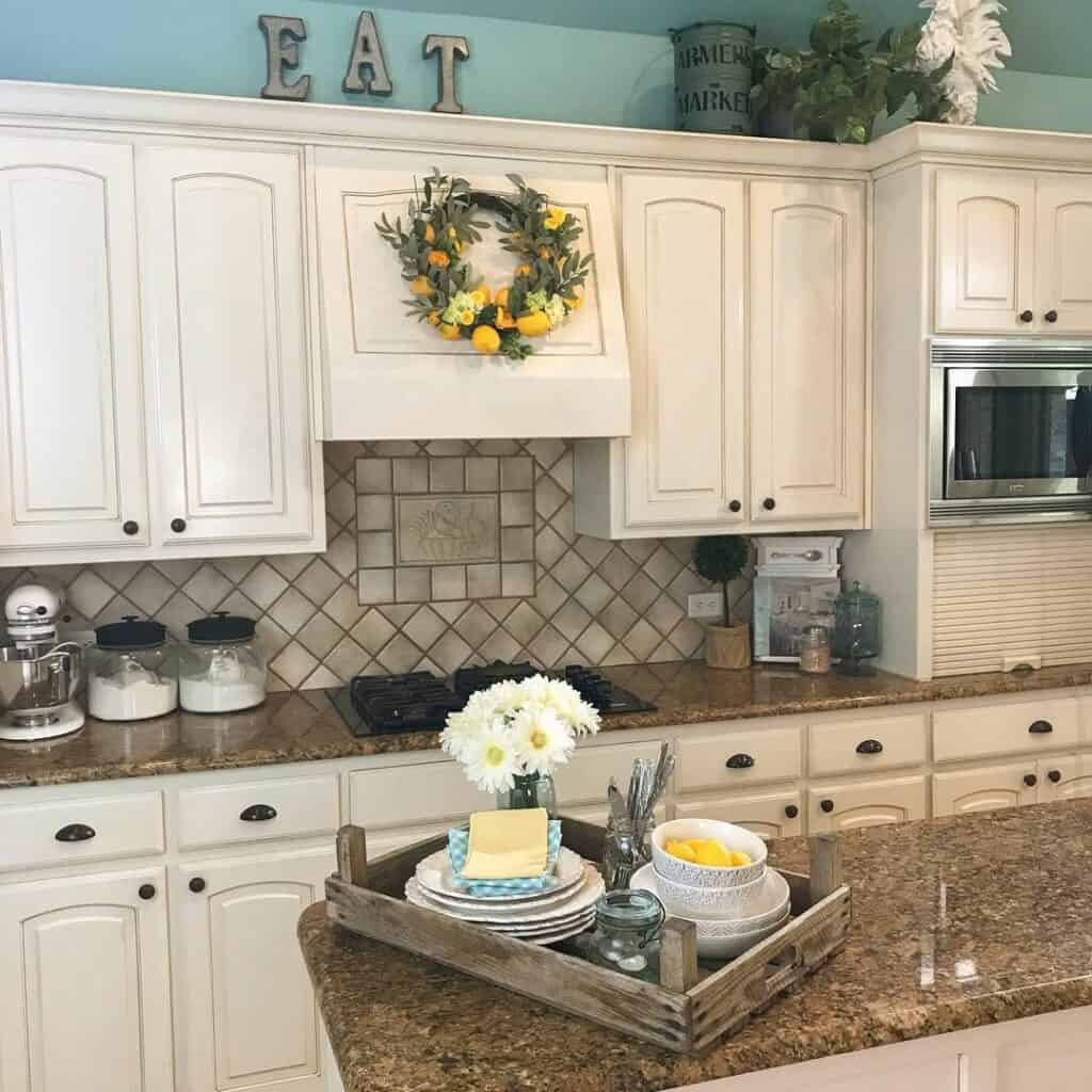 Cream Kitchen Cabinets With Bright Teal Walls
