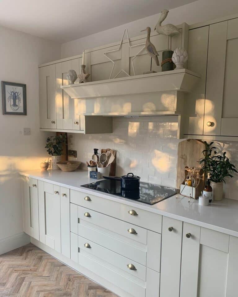 Cream Kitchen Cabinets With Herringbone Wood Flooring