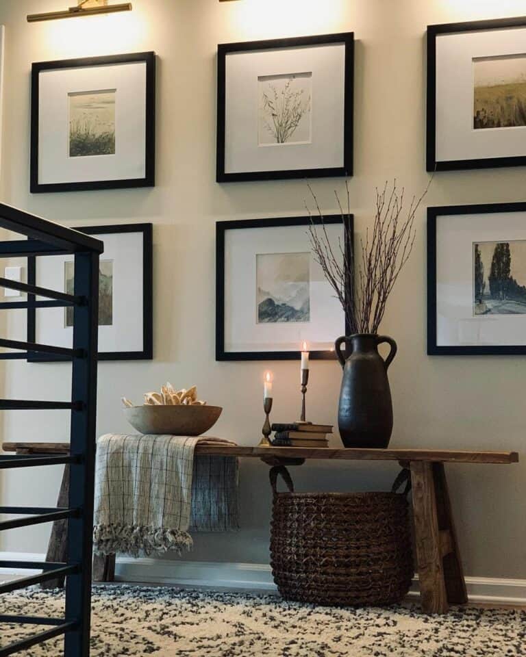 Gallery Wall With Gold Lights and Black-framed Portraits