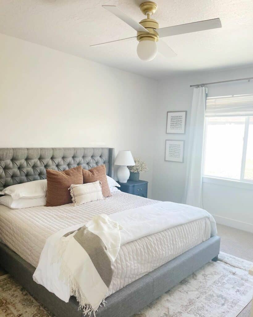 Gray Tufted Bed With Beige Bedding