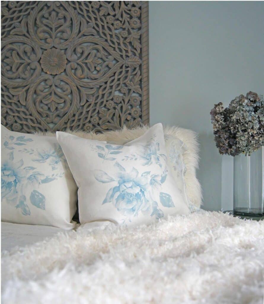 Light Blue Bedroom With Floral Pillows