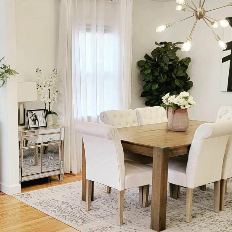 Mirrored Side Table Beside Sheer Drapes