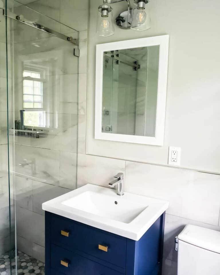 Navy and White Bathroom With a Small Shower