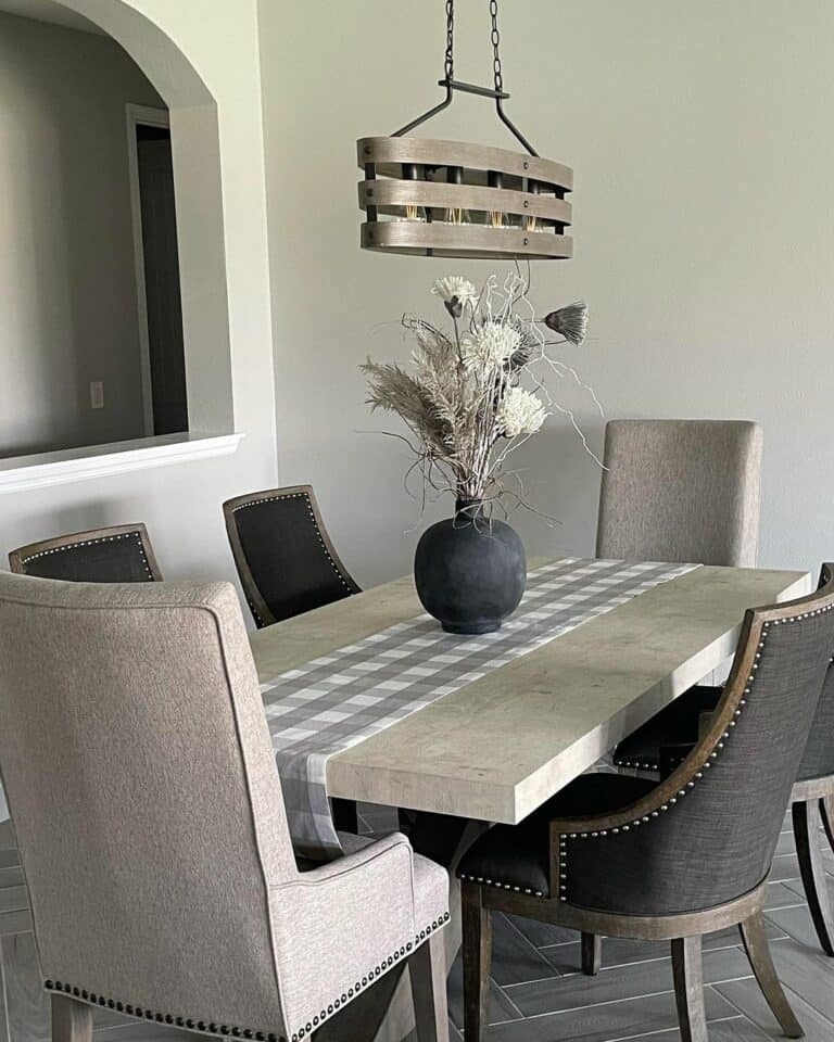 Quiet Dining Space With a Gray Herringbone Tile Floor