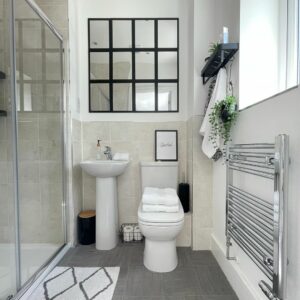Simple Small Bathroom With Black Grid Mirror