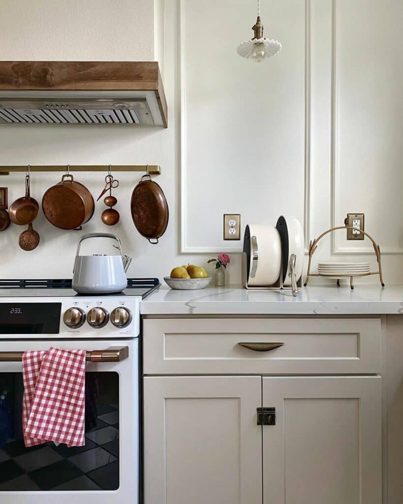 https://www.soulandlane.com/wp-content/uploads/2023/04/White-Appliances-Next-to-Cream-Kitchen-Cabinets-819x1024.jpg