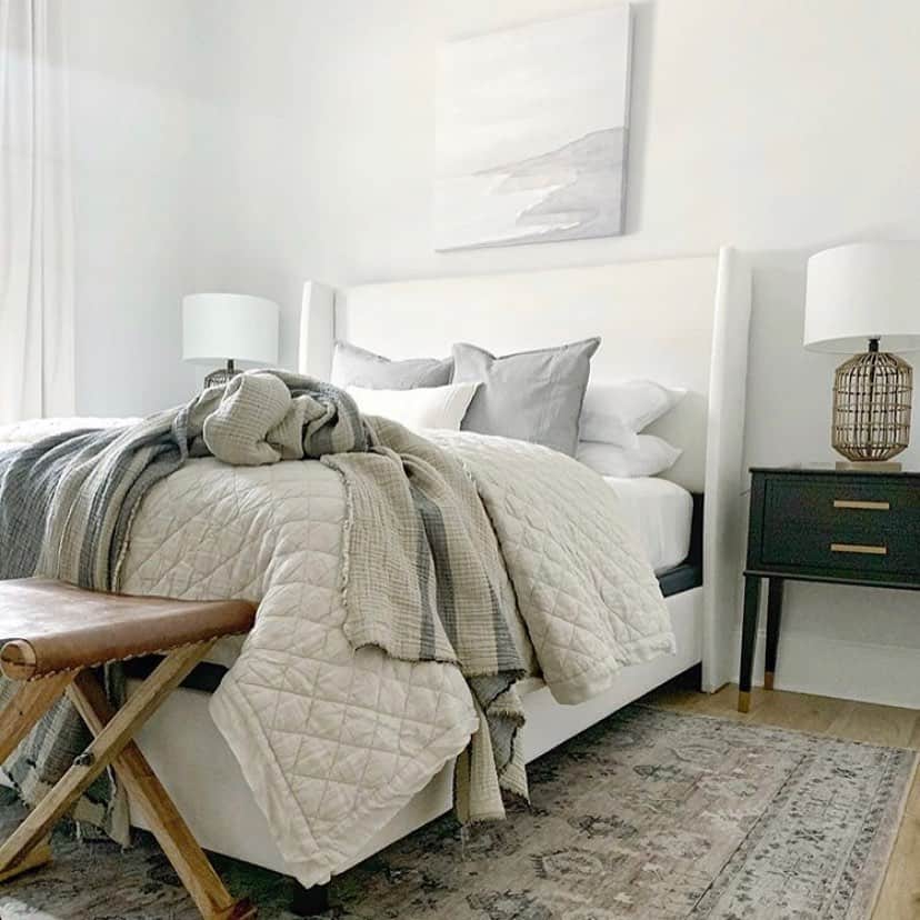 White Bed With Grey and Beige Bedding