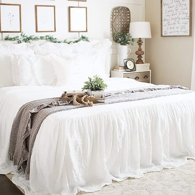 White Bedding Flows Onto a Rug