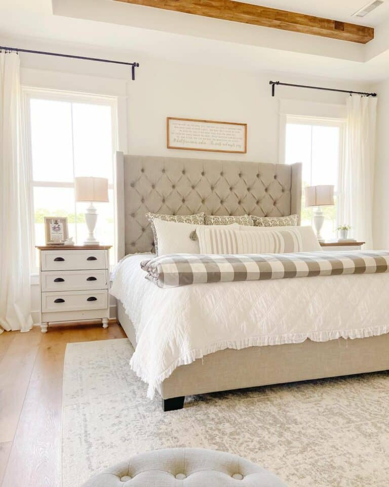 White Farmhouse Bedroom With Greige Tufted Bed
