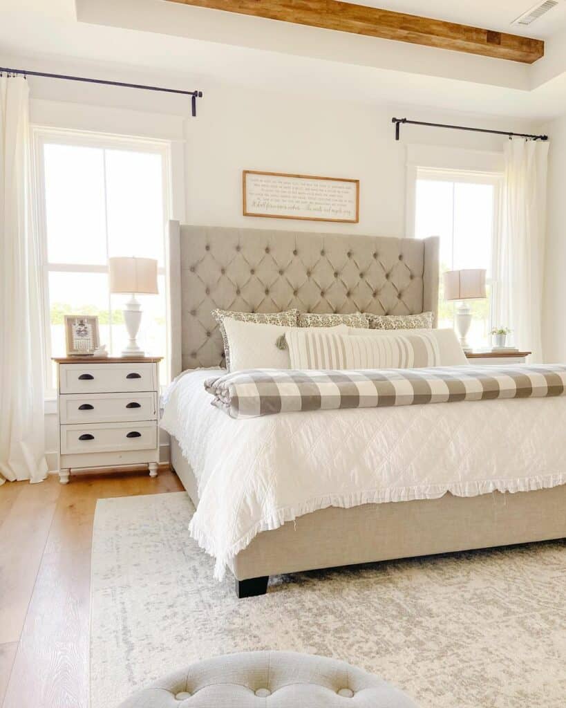 White Farmhouse Bedroom With Greige Tufted Bed
