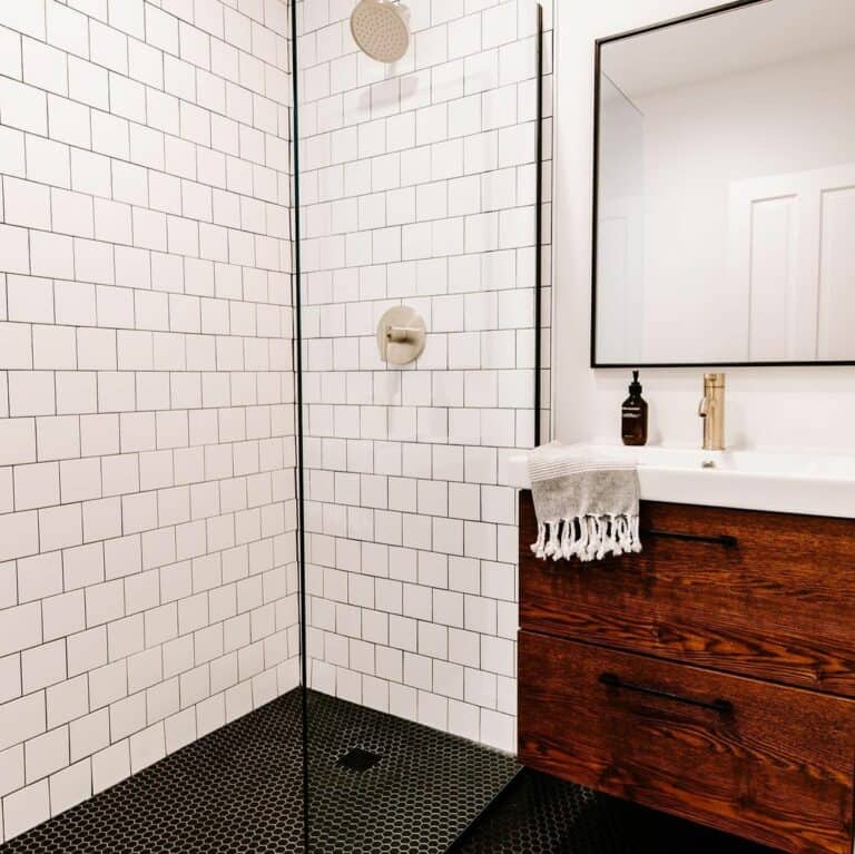 White Subway Tile Shower and a Black Hexagonal Tile Floor