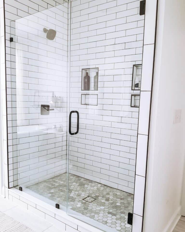 White Subway Tiles and Brown Hexagon Tiles in a Modern Shower