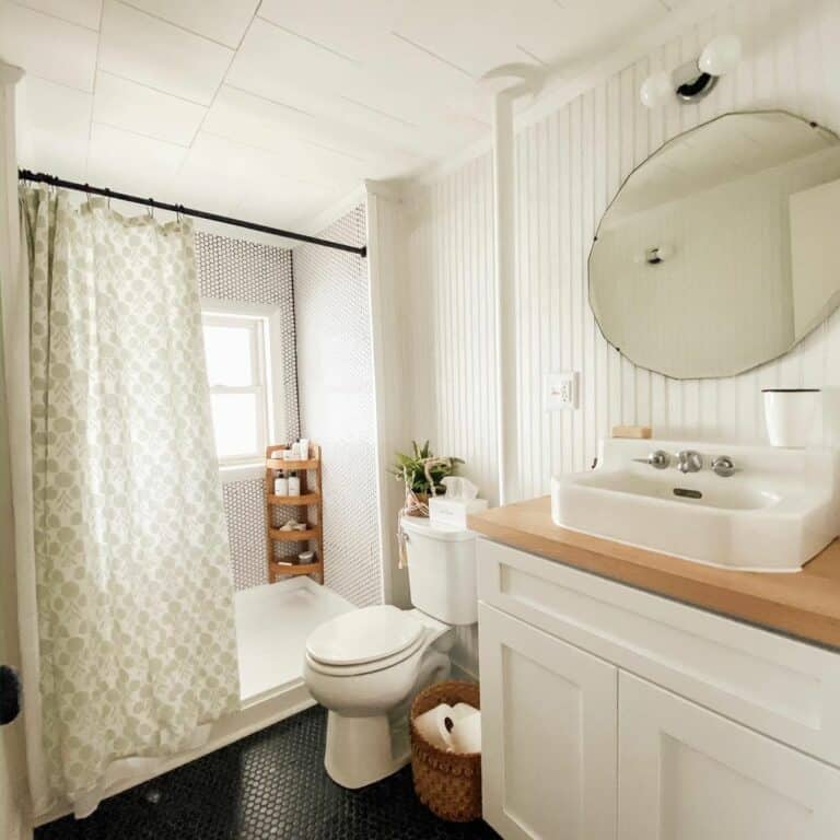 Farmhouse-style Shower With Black Tile Flooring