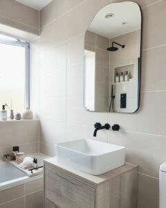 Taupe Tile Bathroom With Stained Wood Washstand