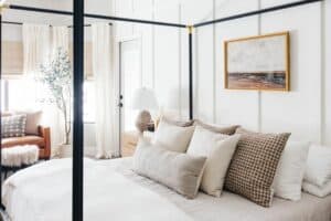 Beach-themed Bedroom With Olive Tree and Black Framed Bed