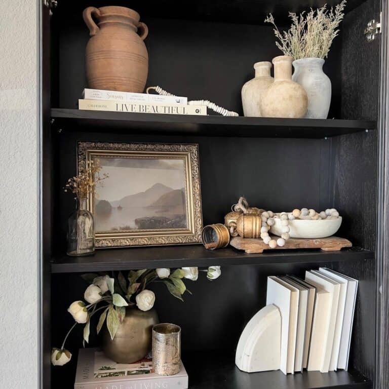Black Bookshelf With Gold Picture Frame