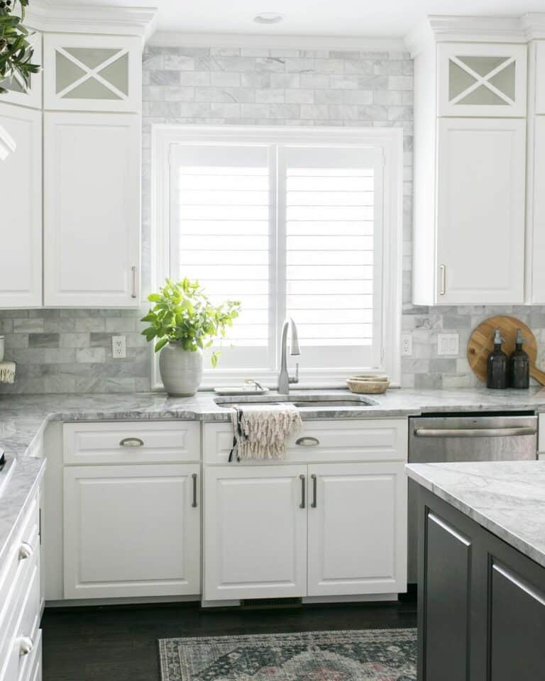 Cool-Toned Kitchen With White Cabinets and Gray Counters