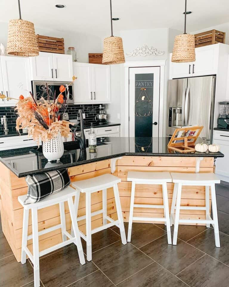 Cozy Farmhouse Kitchen With White Cabinets and Bar Stools