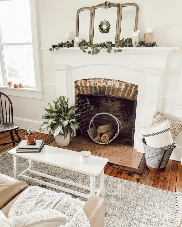 Empty Brick Fireplace With a White Metal Firewood Tray