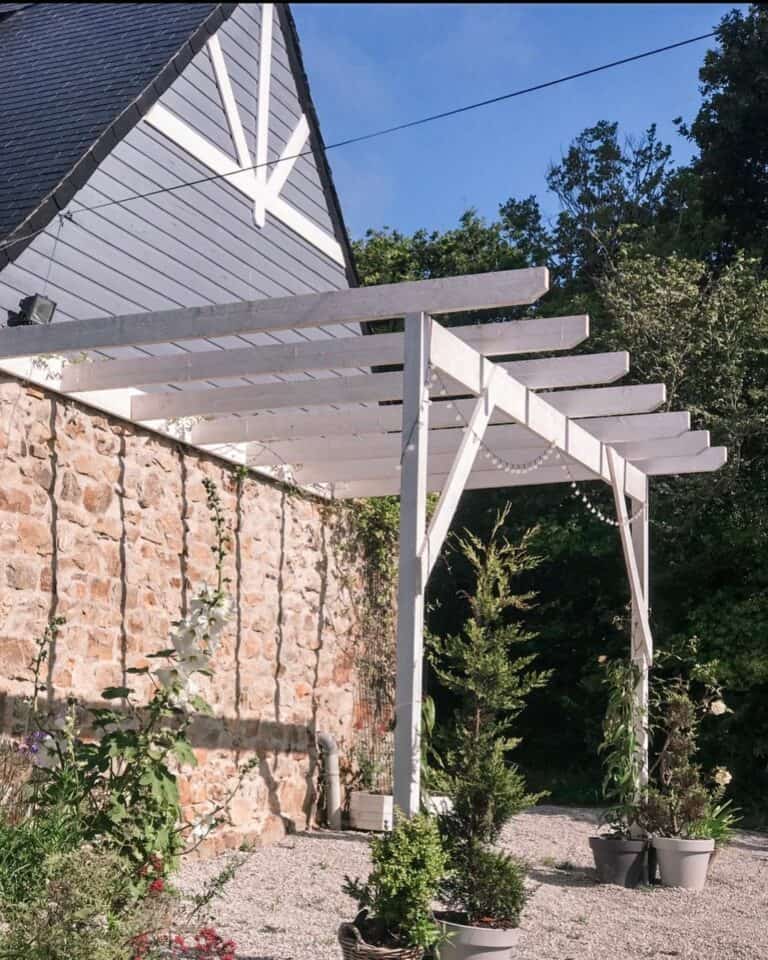 French Farmhouse With White Pergola