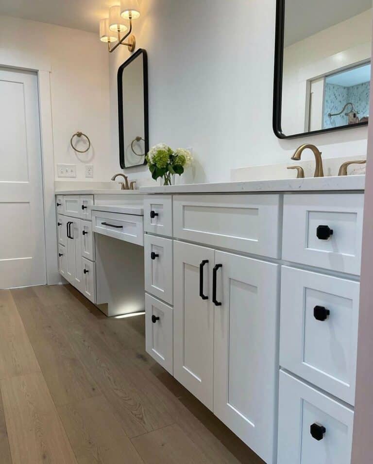 Girl's Bathroom With White Cabinets and Walls