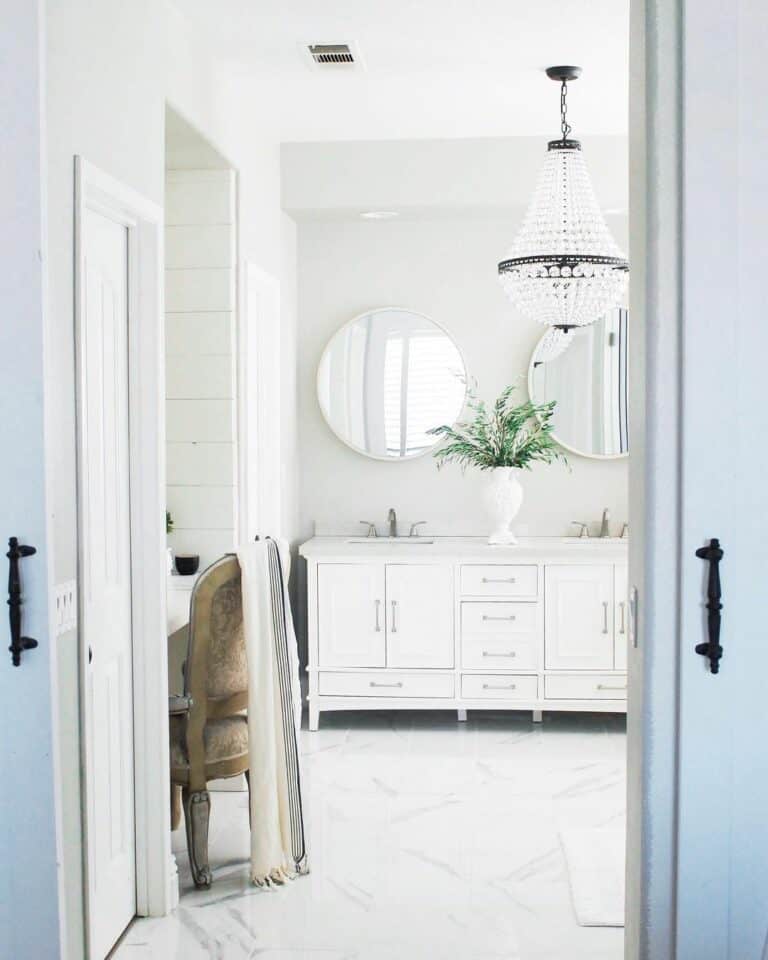 Luxurious White Master Bathroom With a Crystal Chandelier