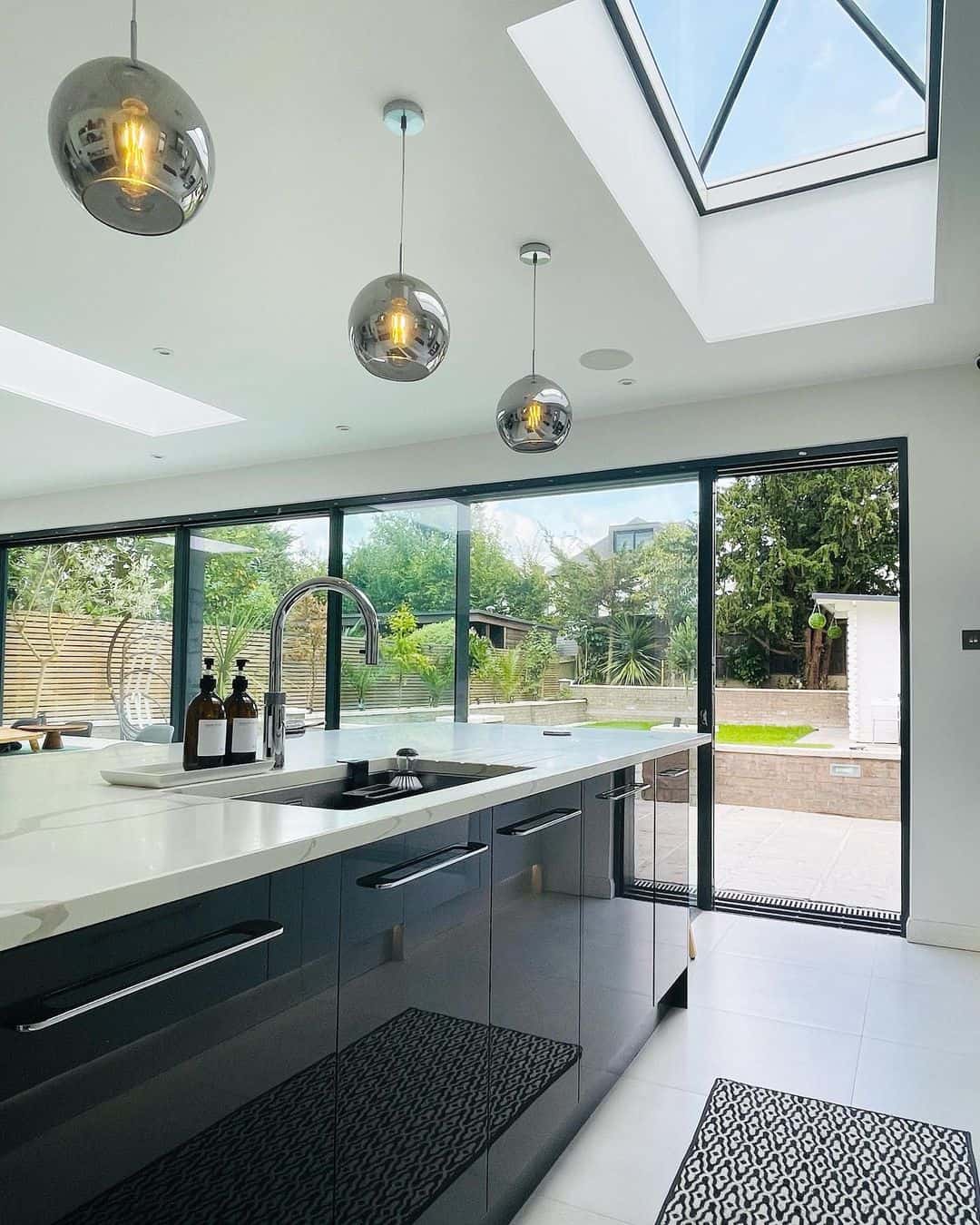 Modern Black and White Kitchen With a Large Skylight Soul & Lane