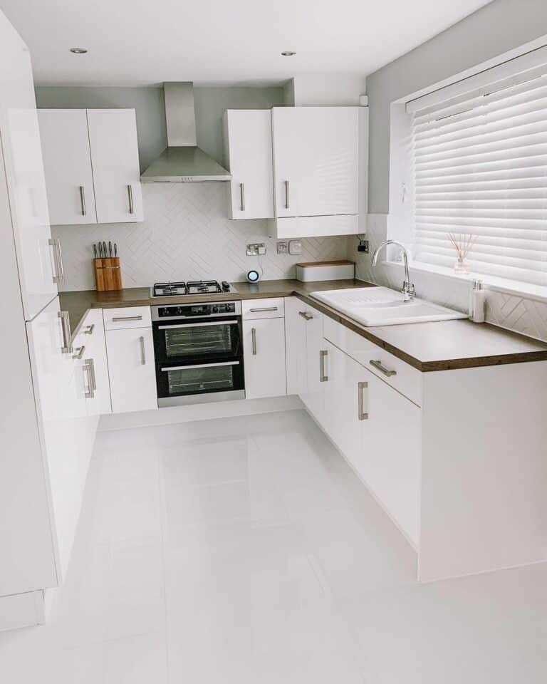 Neutral Kitchen With Stainless Hardware and Appliances