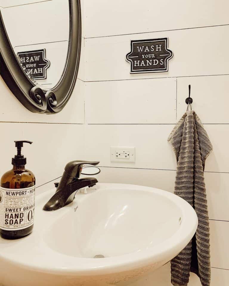 Quaint Guest Bathroom With White Shiplap Panels