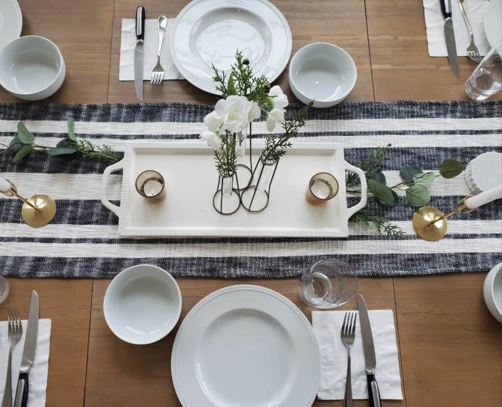 Simple White Tableware Borders a Striped Runner