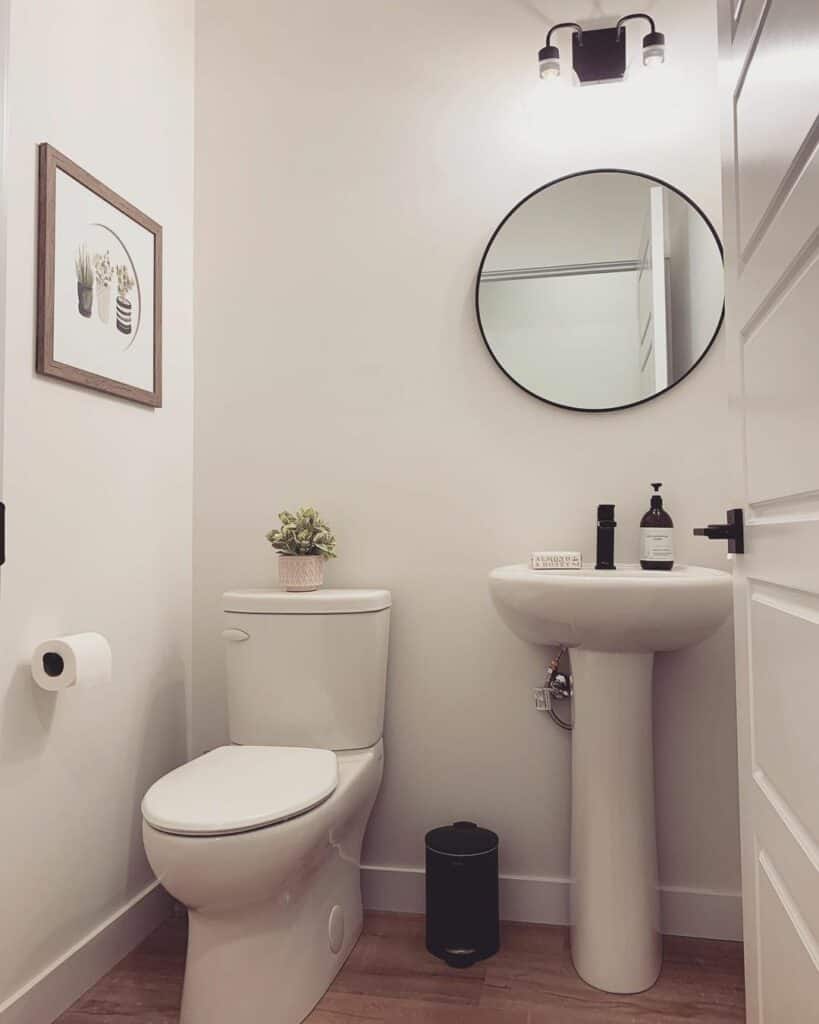 Small Powder Room With a Modern Vanity Mirror and Light