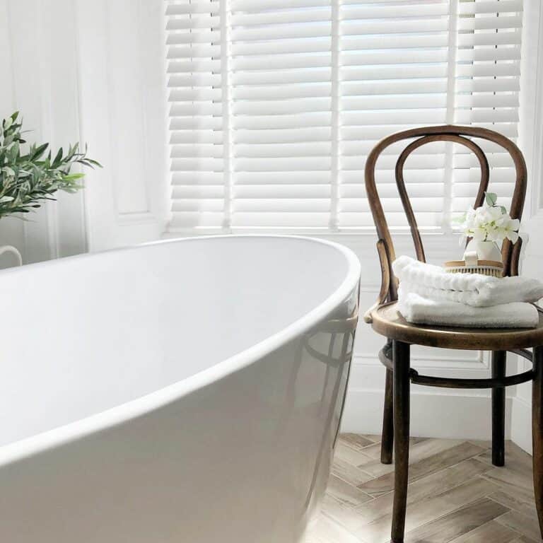 White Bathroom With a Freestanding Tub and Rustic Décor