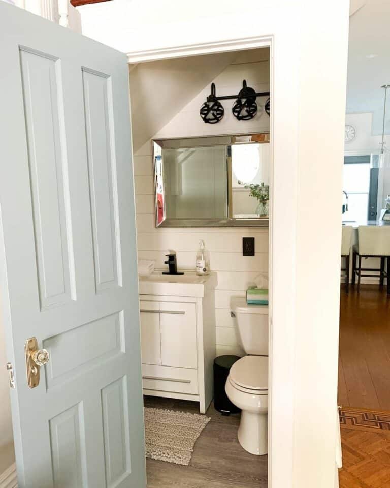 White Cottage Rustic Powder Room With Pastel Door