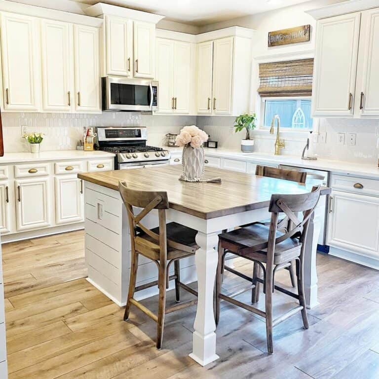 White Farmhouse Kitchen With a Butcher Block Island Counter