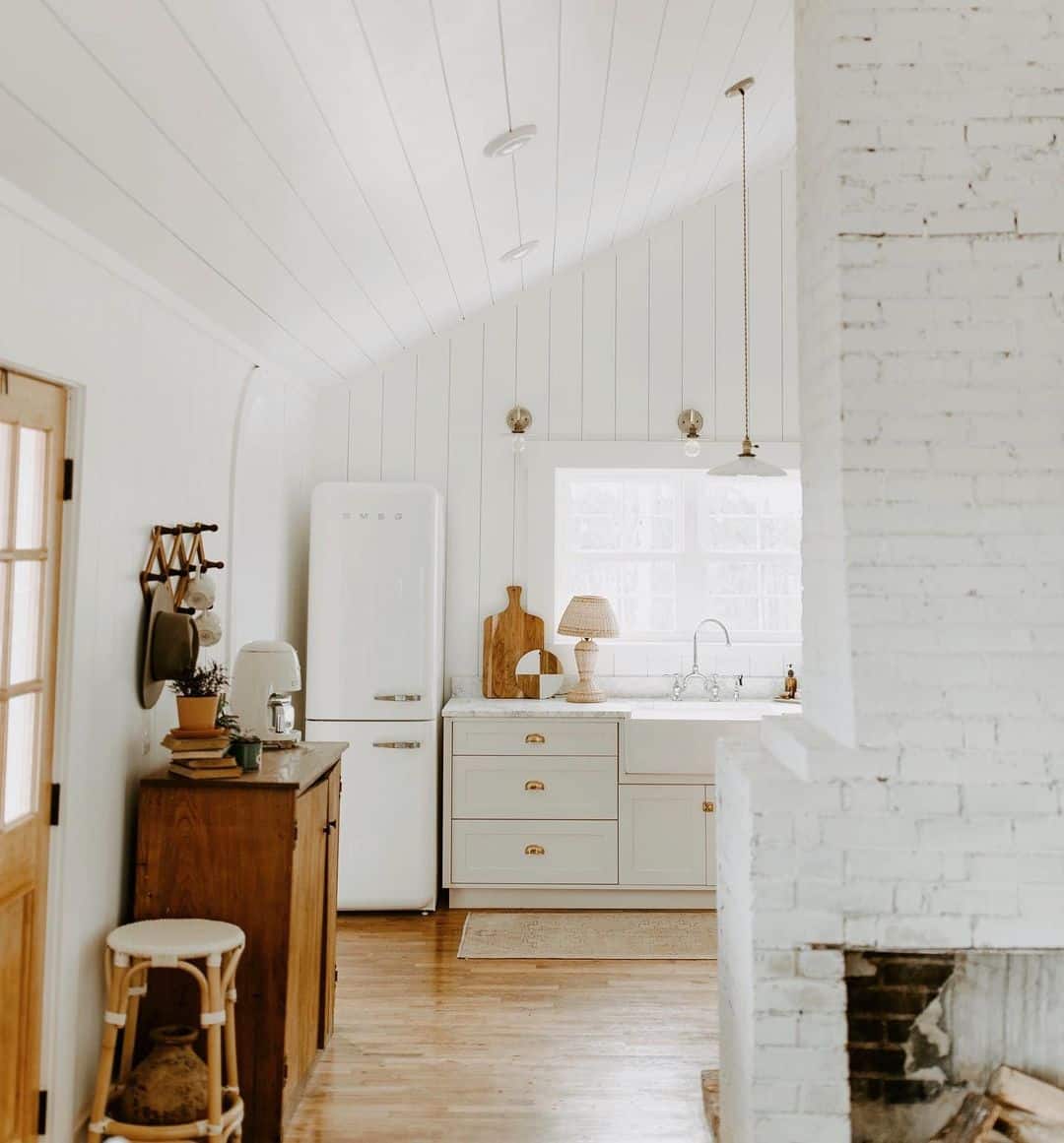 White Kitchen With Rustic Brick Walls and Wooden Ceilings - Soul & Lane