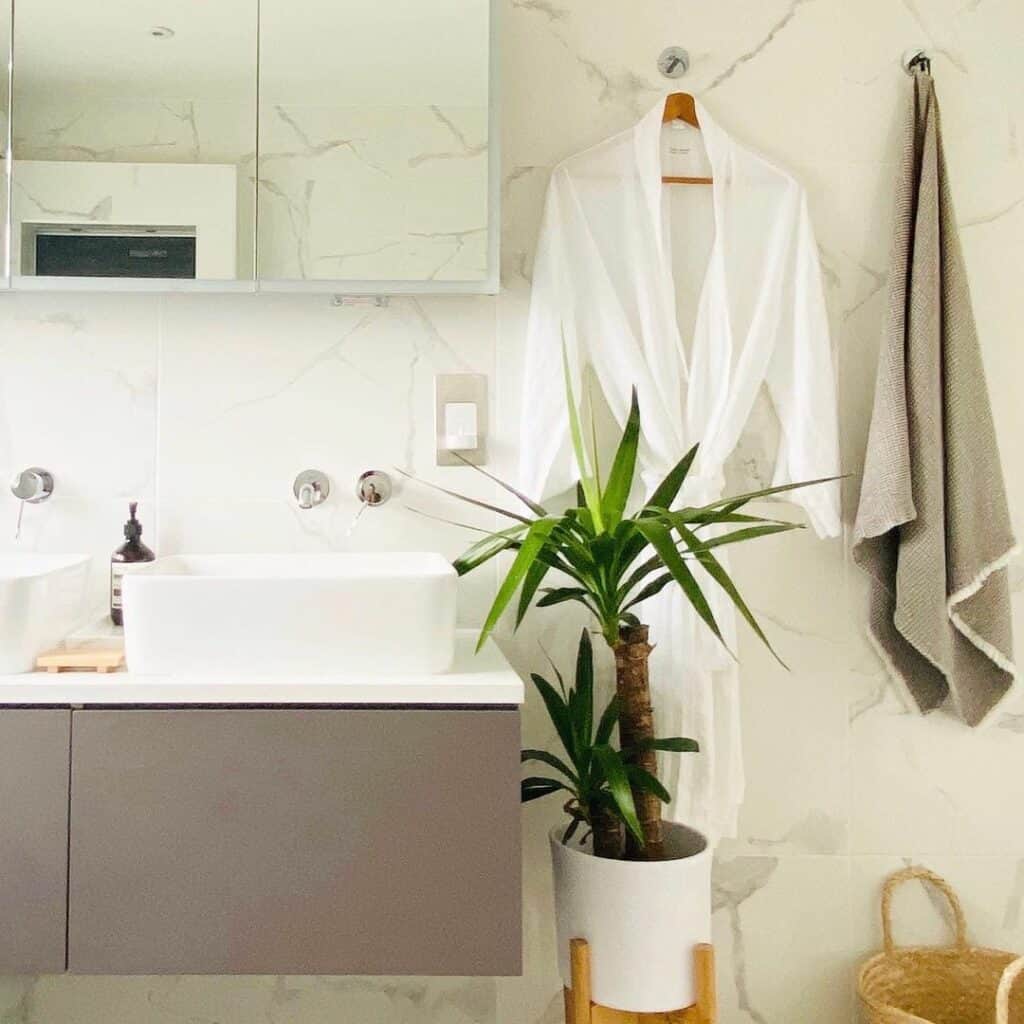 White Marble Bathroom With Chrome Towel Hooks