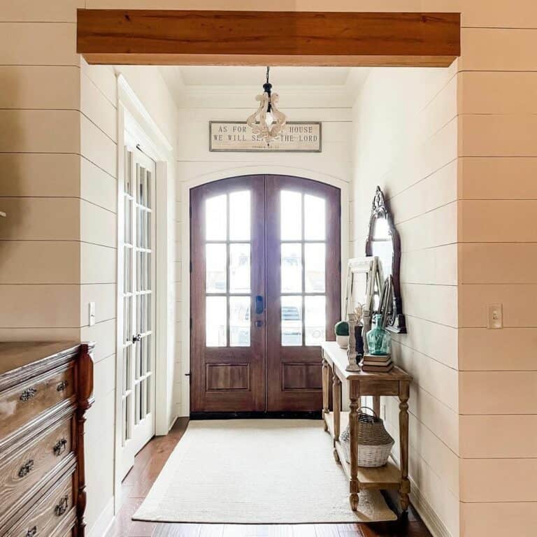 White Shiplap Entrance Hall With Stained Wood Doors
